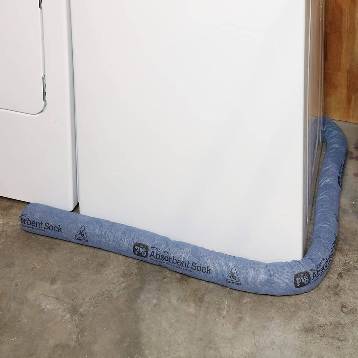 Blue absorbent sock laid along floor next to a cabinet base