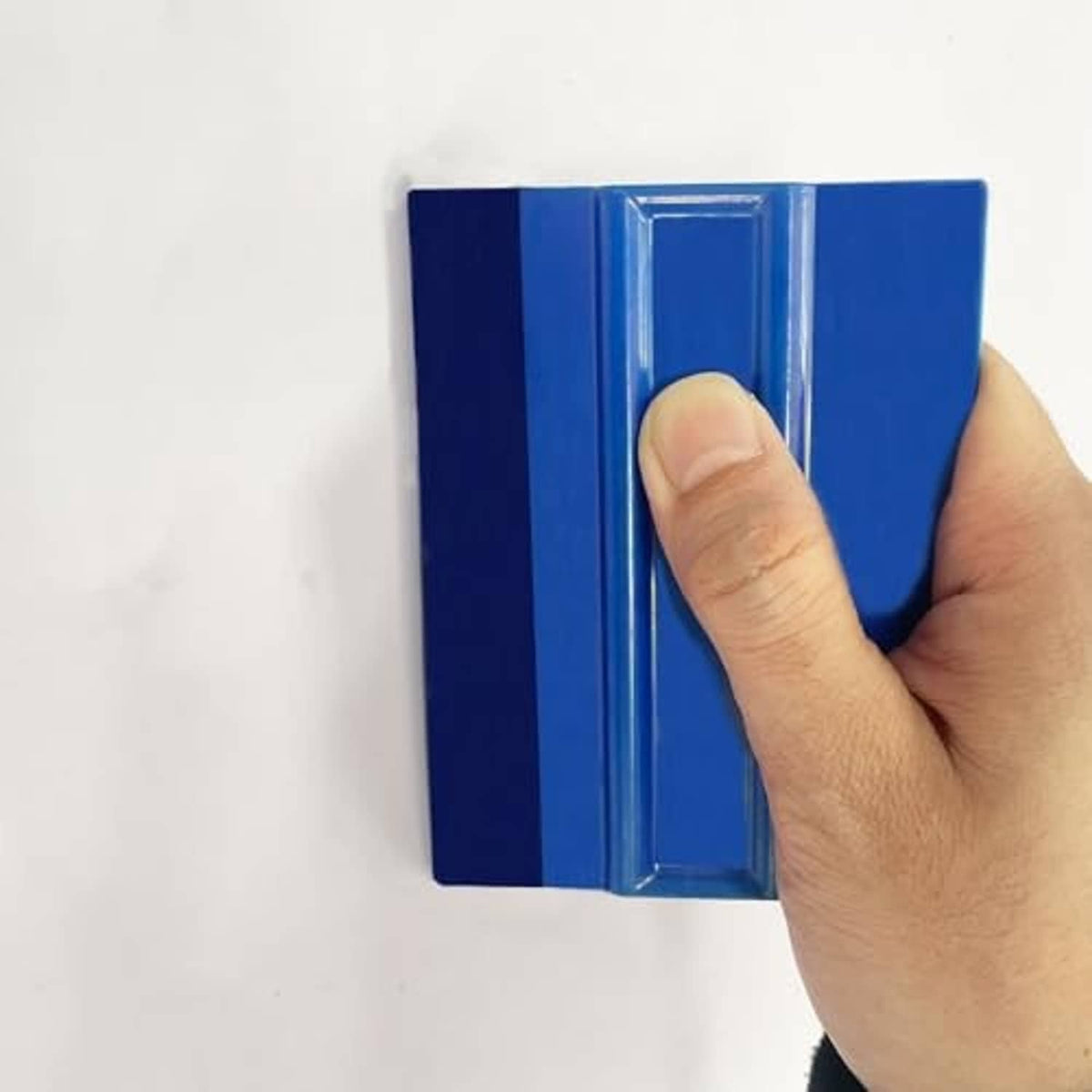 Close-up of blue felt squeegee blade with clear center strip and finger grip