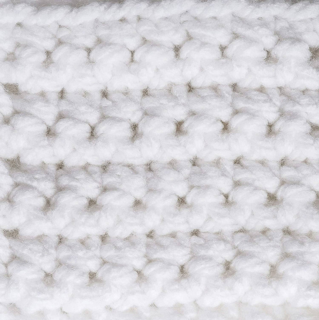 Close-up of white chunky acrylic yarn texture with nubby looped stitch pattern