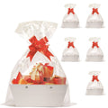 White gift basket with clear wrap, red bow, and ribbon-tied gift inside