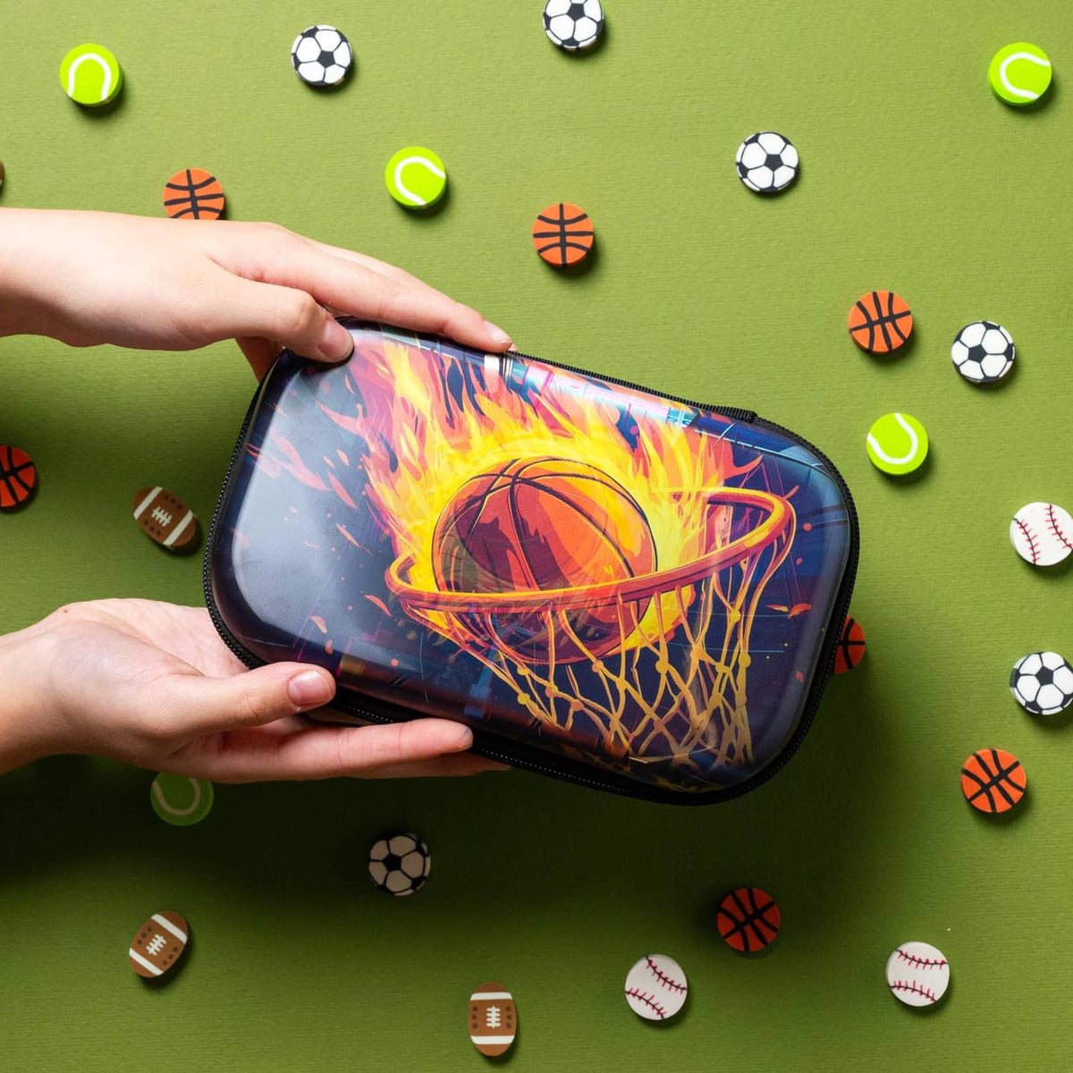 ZIPIT 3D basketball pencil case held in hands, blue base and black zipper.