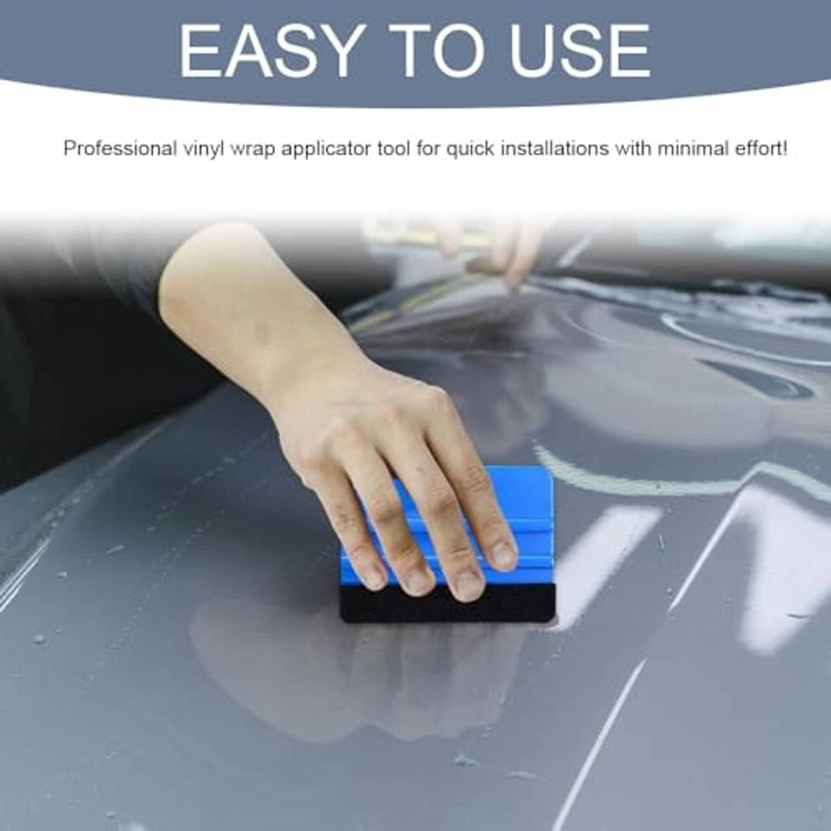 Hand using blue felt-edge squeegee to smooth clear vinyl film on a window