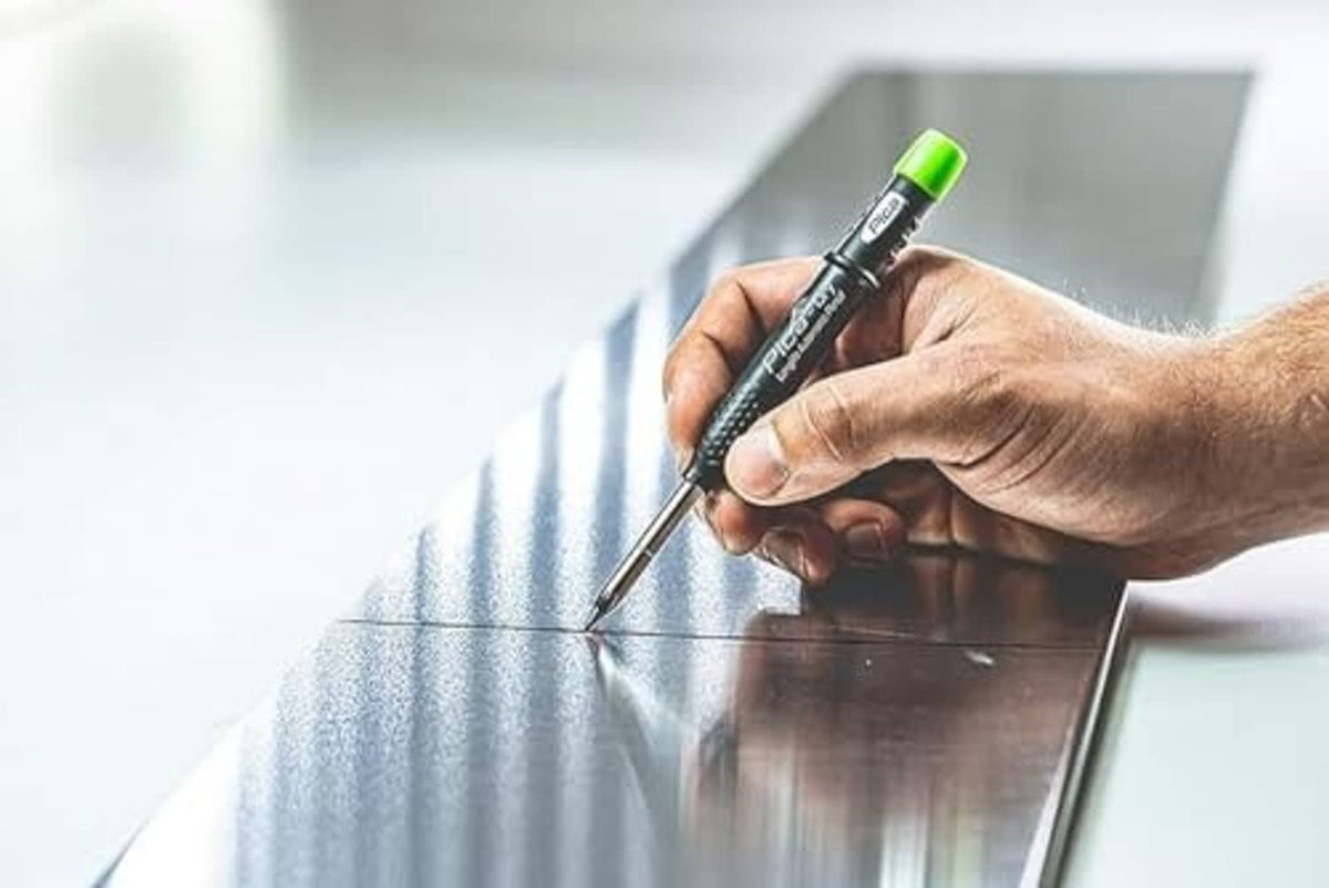 Automatic pencil with black body and neon-green cap held in a hand