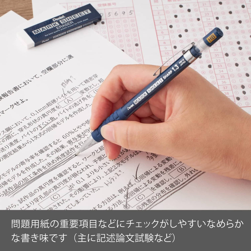 Hand holding blue 1.3mm HB mechanical pencil over printed test sheet