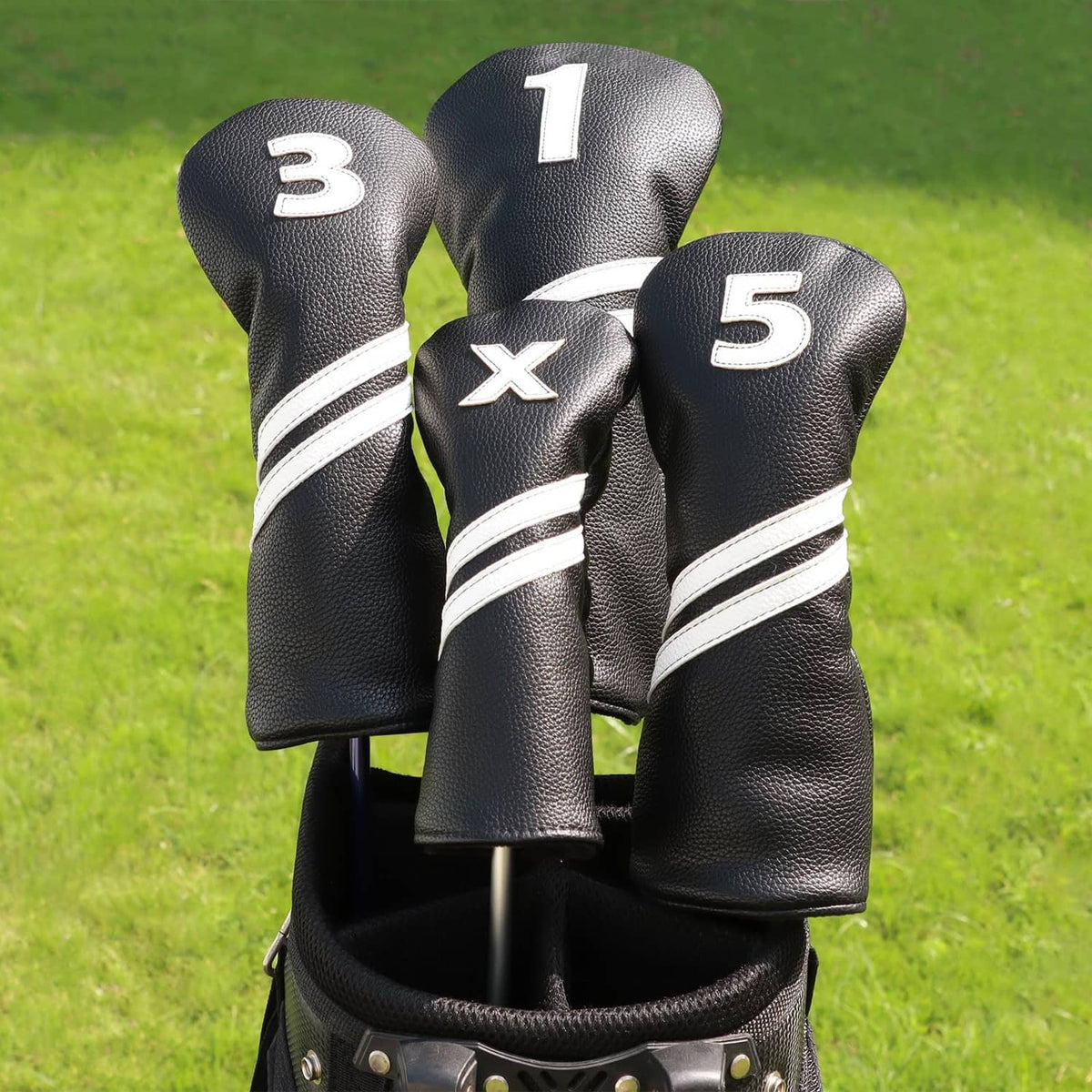 Group of black hybrid headcovers with X mark and numbers 1, 3, and 5, white stripes