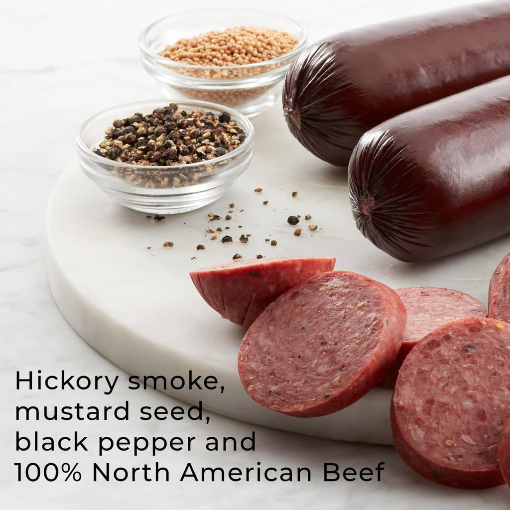 Beef Summer Sausage link with sliced rounds beside mustard seeds, pepper, and cheese