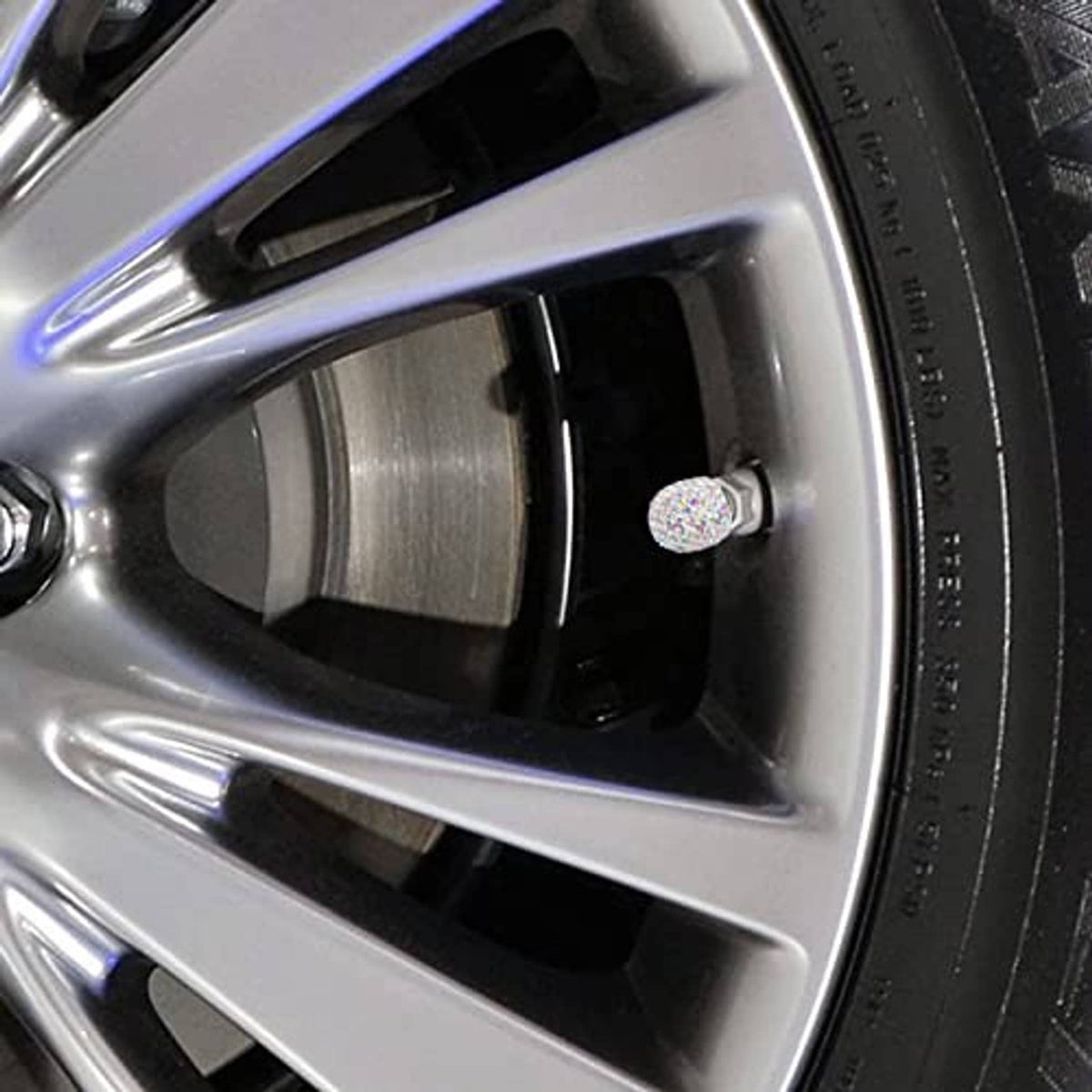 Multicolor AB rhinestone tire valve stem cap on silver wheel spoke