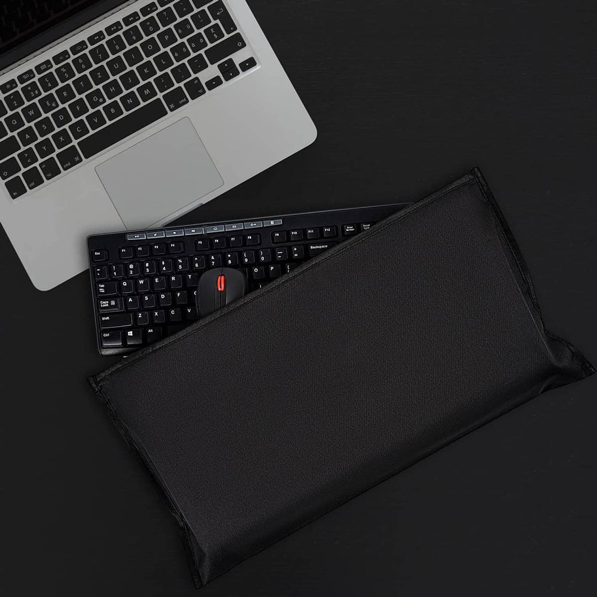 Black dust cover pouch laid open with a keyboard and mouse inside