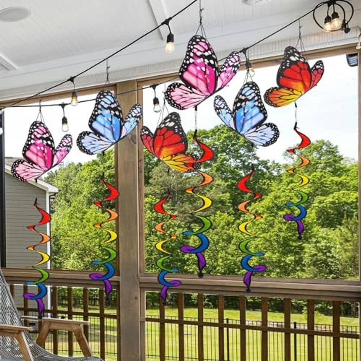 Multiple hanging butterfly windsocks with red, pink, and blue spiral ribbon streamers