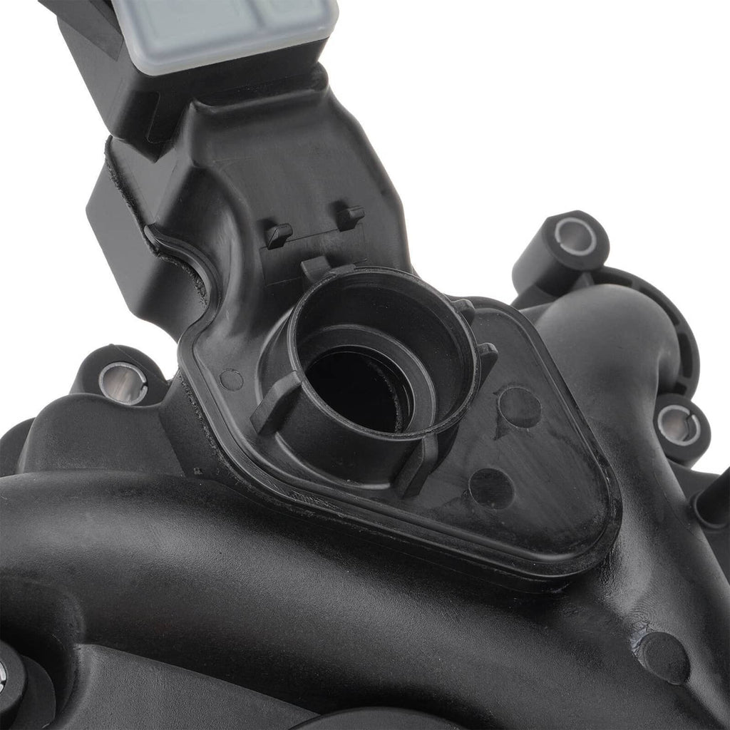 Close-up of black oil separator housing with circular port opening and mounting points