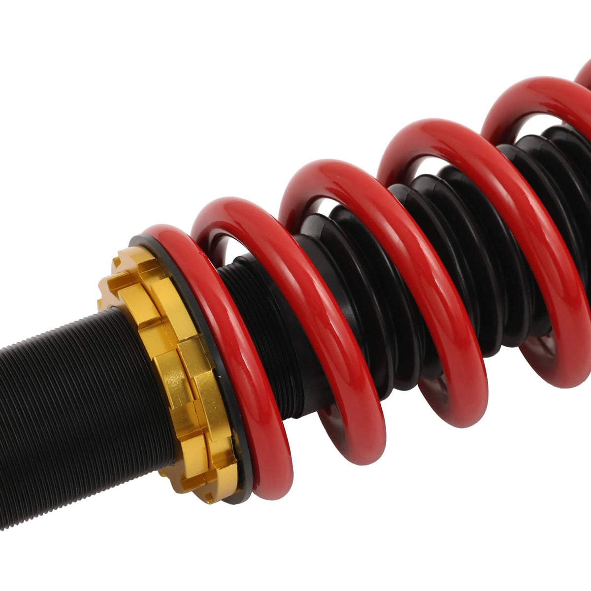 Close-up of red coil spring around black shock body with gold mounting ring.