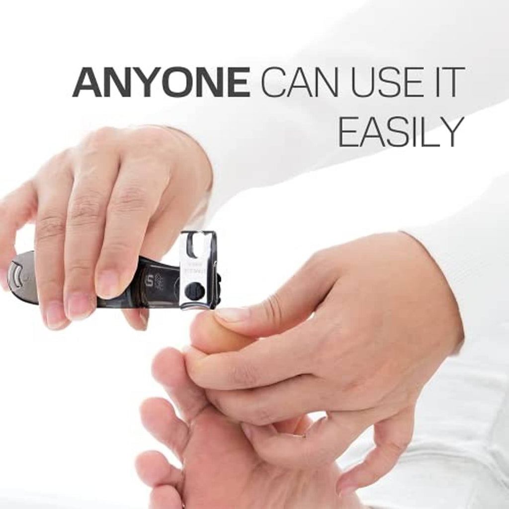 Nail clipper in use on fingernails, black handle and stainless cutting edge
