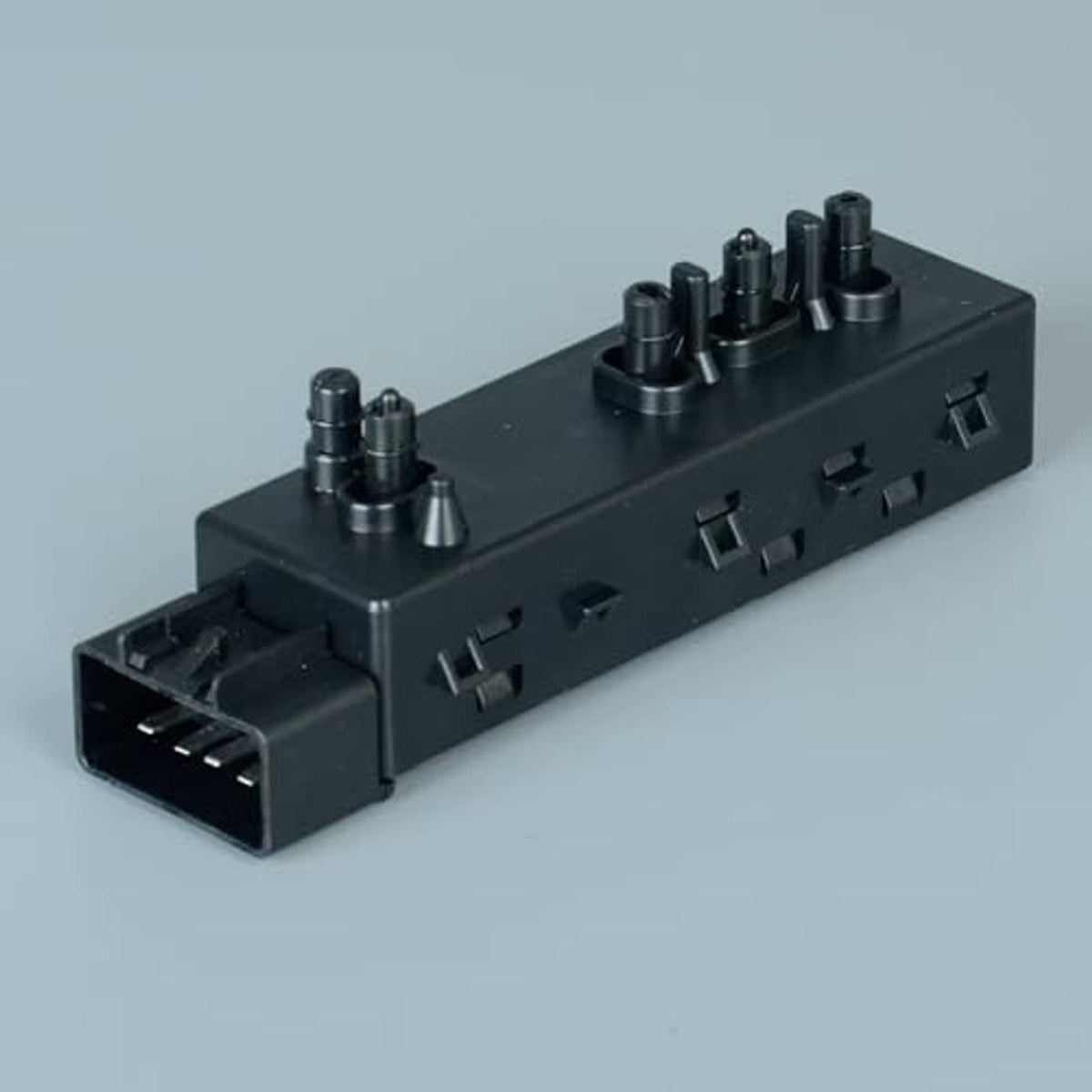 Power seat switch module with black housing, orange lever, and top multi-adjust knobs