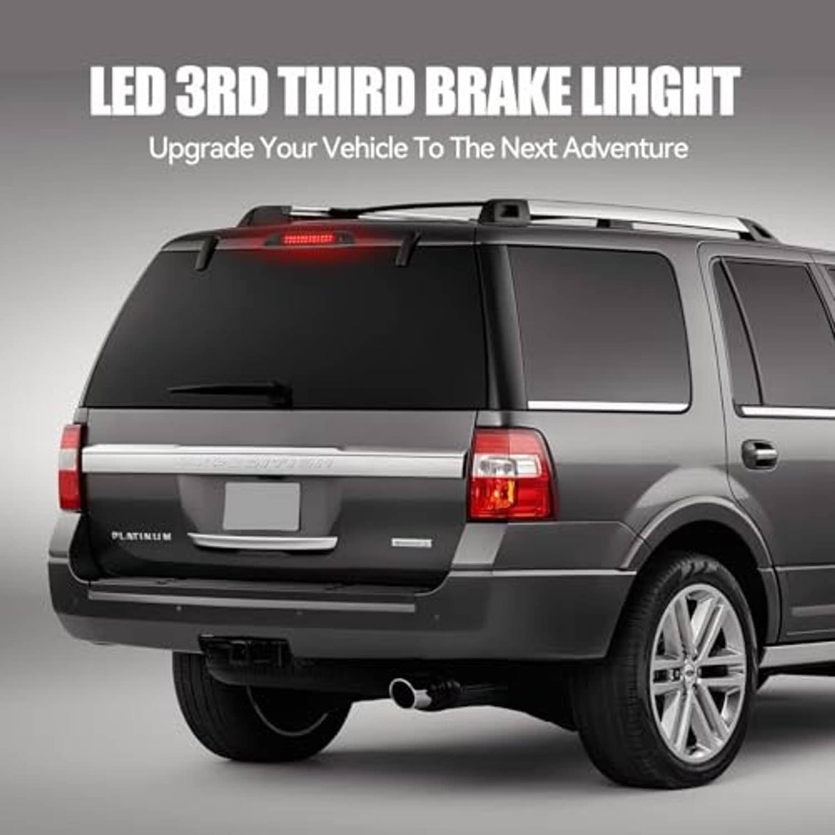 Vehicle rear third brake light LED assembly glowing red, mounted above the doors