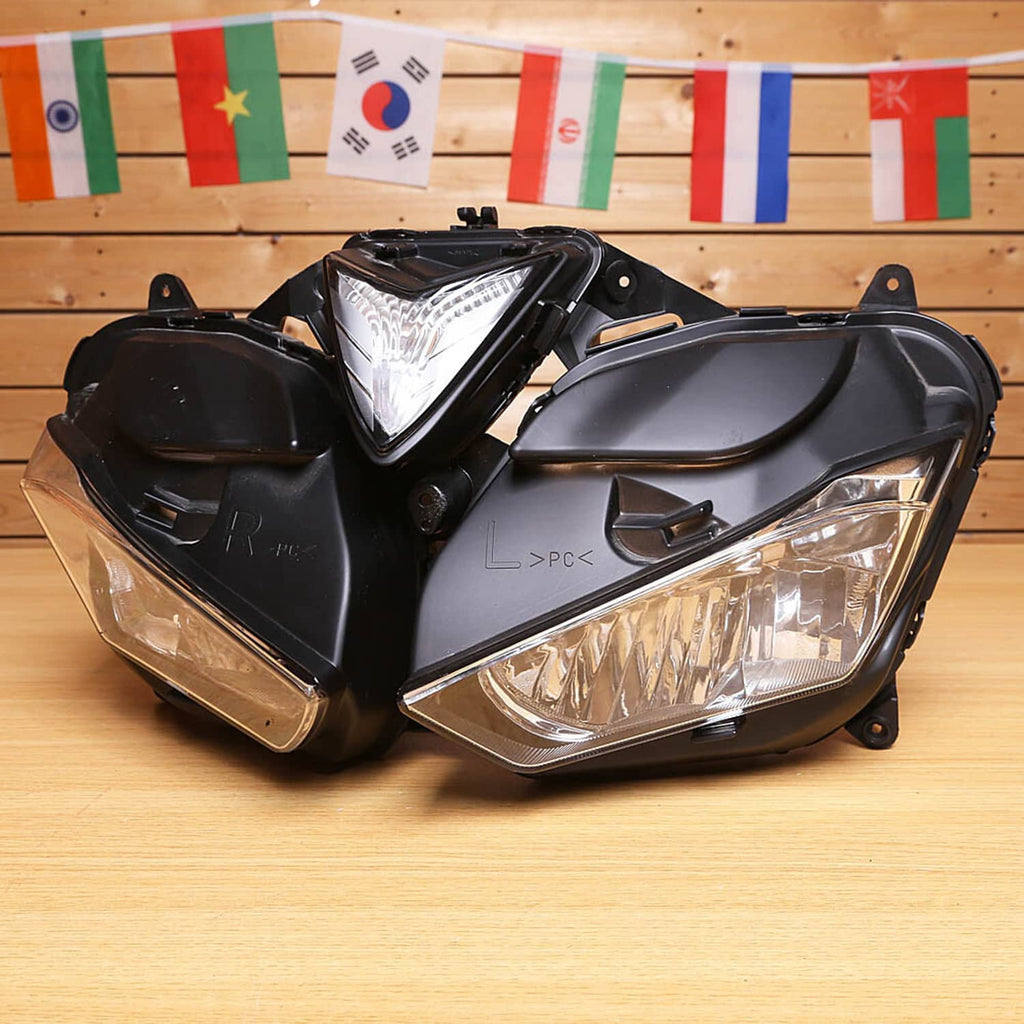 Clear-lens motorcycle headlight assembly with black housing, angled front view