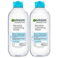 Two Garnier SkinActive micellar cleansing water bottles with blue caps, waterproof makeup remover.