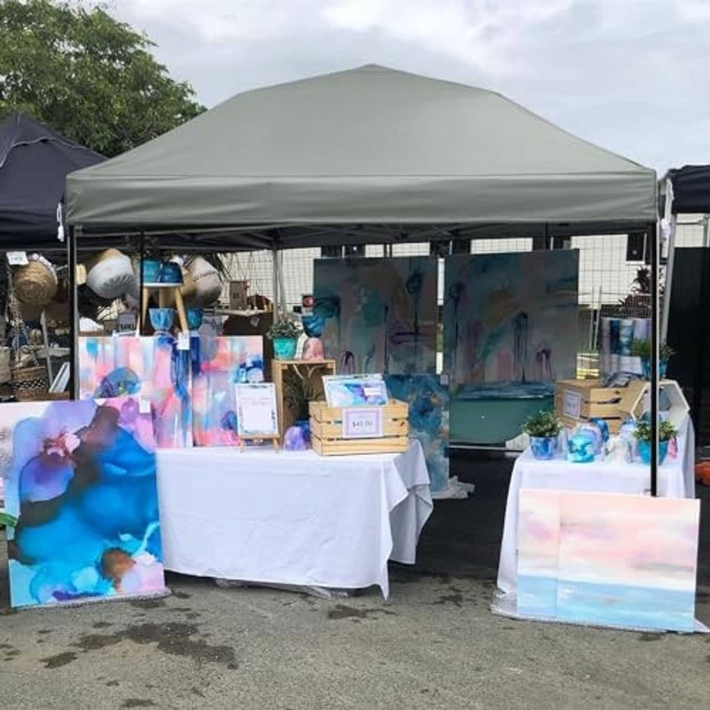 Gray canopy replacement top over a market booth with open sides