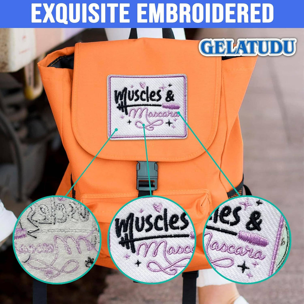 Embroidered 'Muscles & Mascara' patch displayed on an orange backpack.