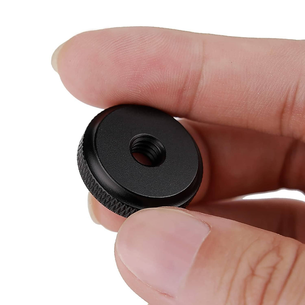 Black thumb wheel lock nut close-up with textured edge and threaded hole