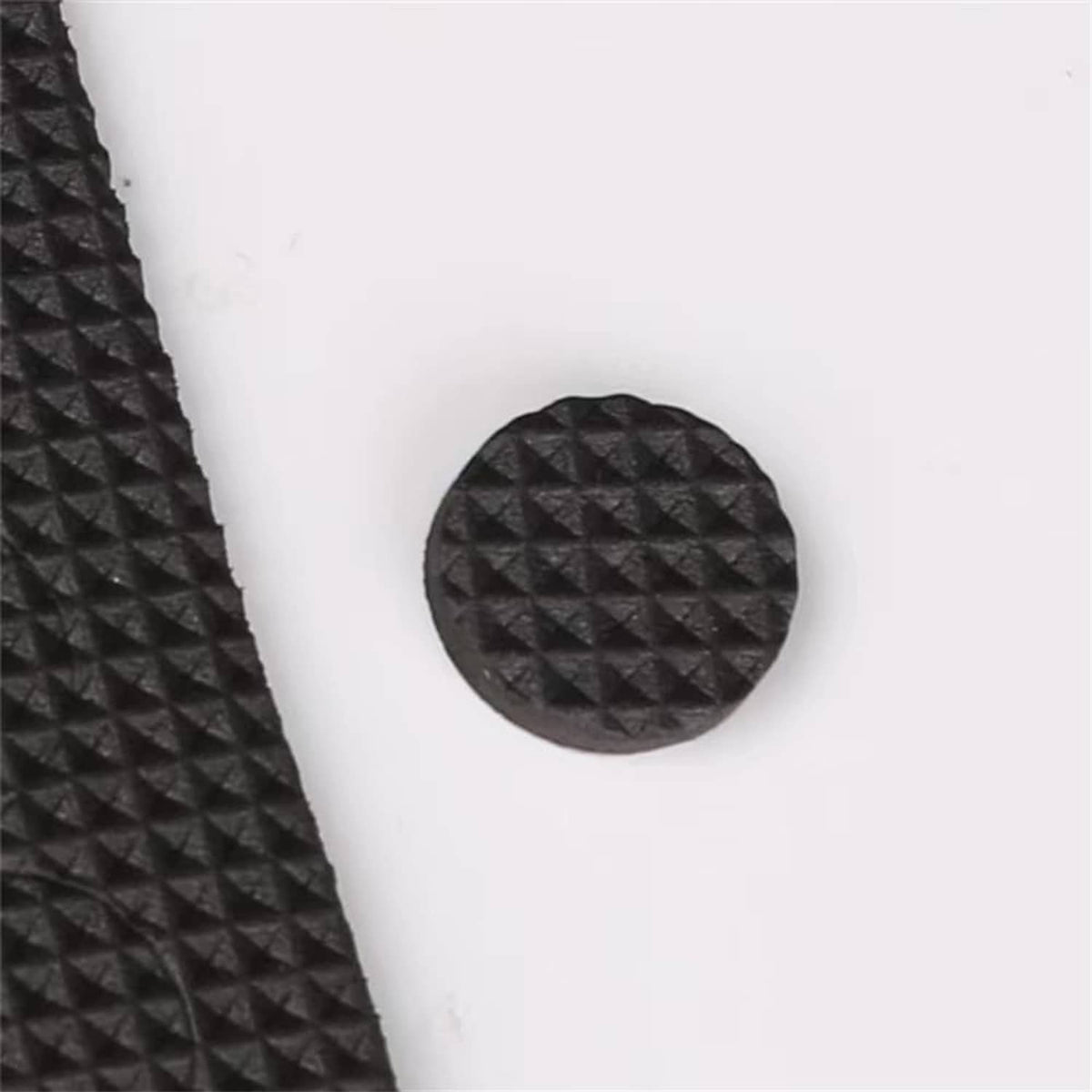 Round black felt furniture pad with textured surface on furniture contact area