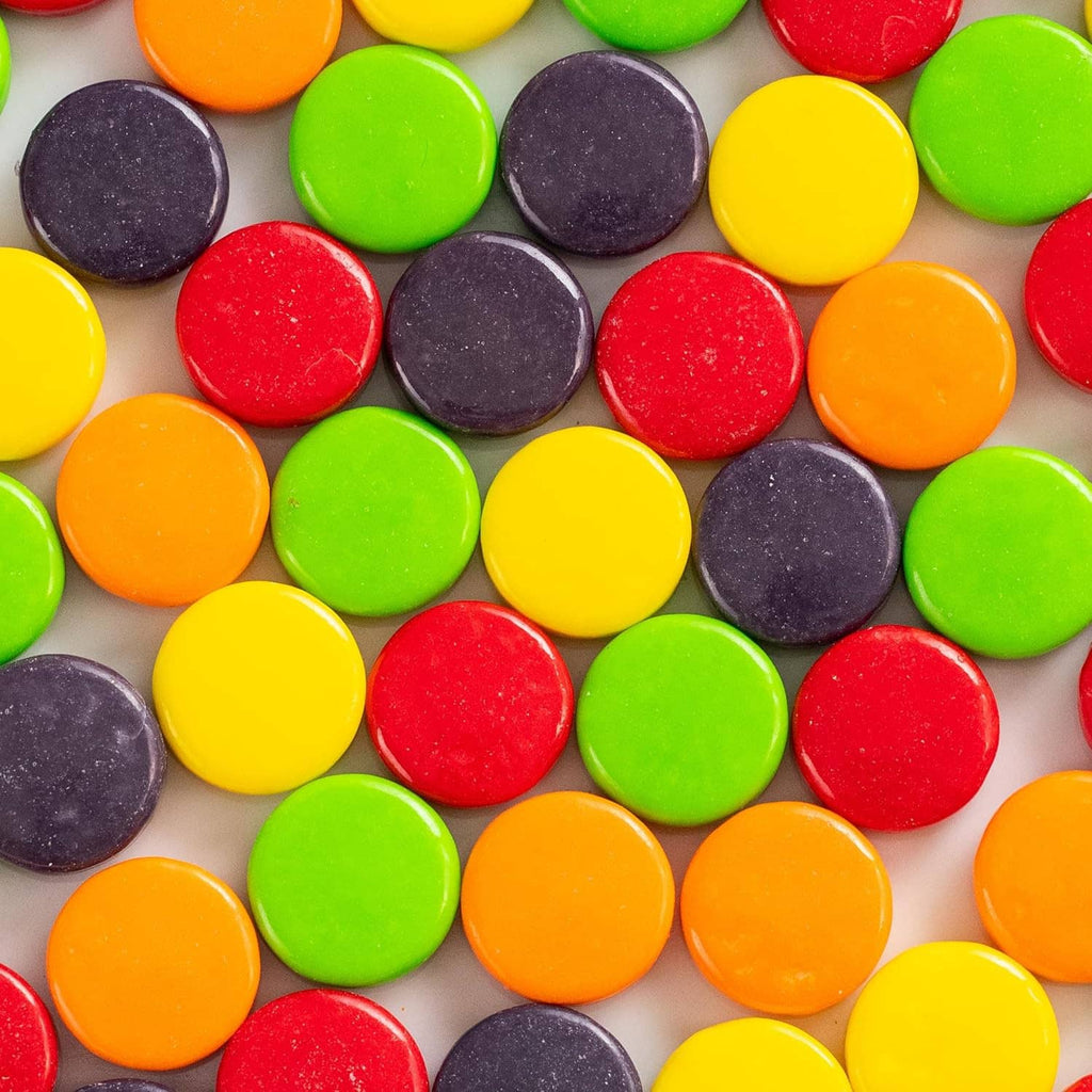 Assorted round hard candy pieces in red, purple, orange, yellow, and green