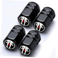 Set of four black tire valve caps with red flame graphic on round tops.