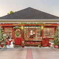Christmas toy shop garage door banner with red doors, snowman, wreath, and festive lights