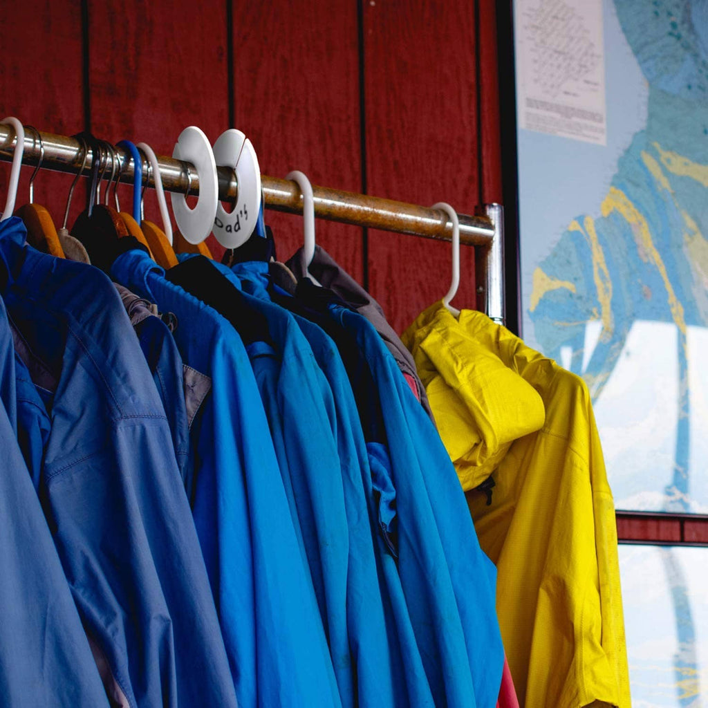 Closet clothing on hangers along a metal rack with colorful garments