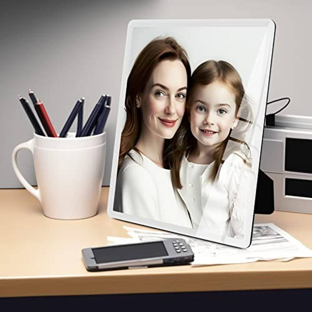 White 8x10 portrait picture frame standing on desk with photo inside.