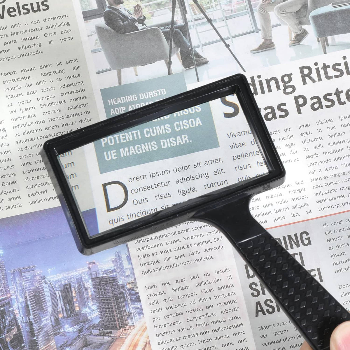 Black rectangular magnifier with clear lens and textured grip, handheld