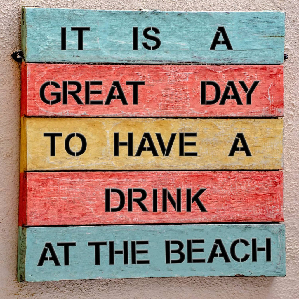 Painted wood sign with stencil-style quote text: IT IS A GREAT DAY TO HAVE A DRINK