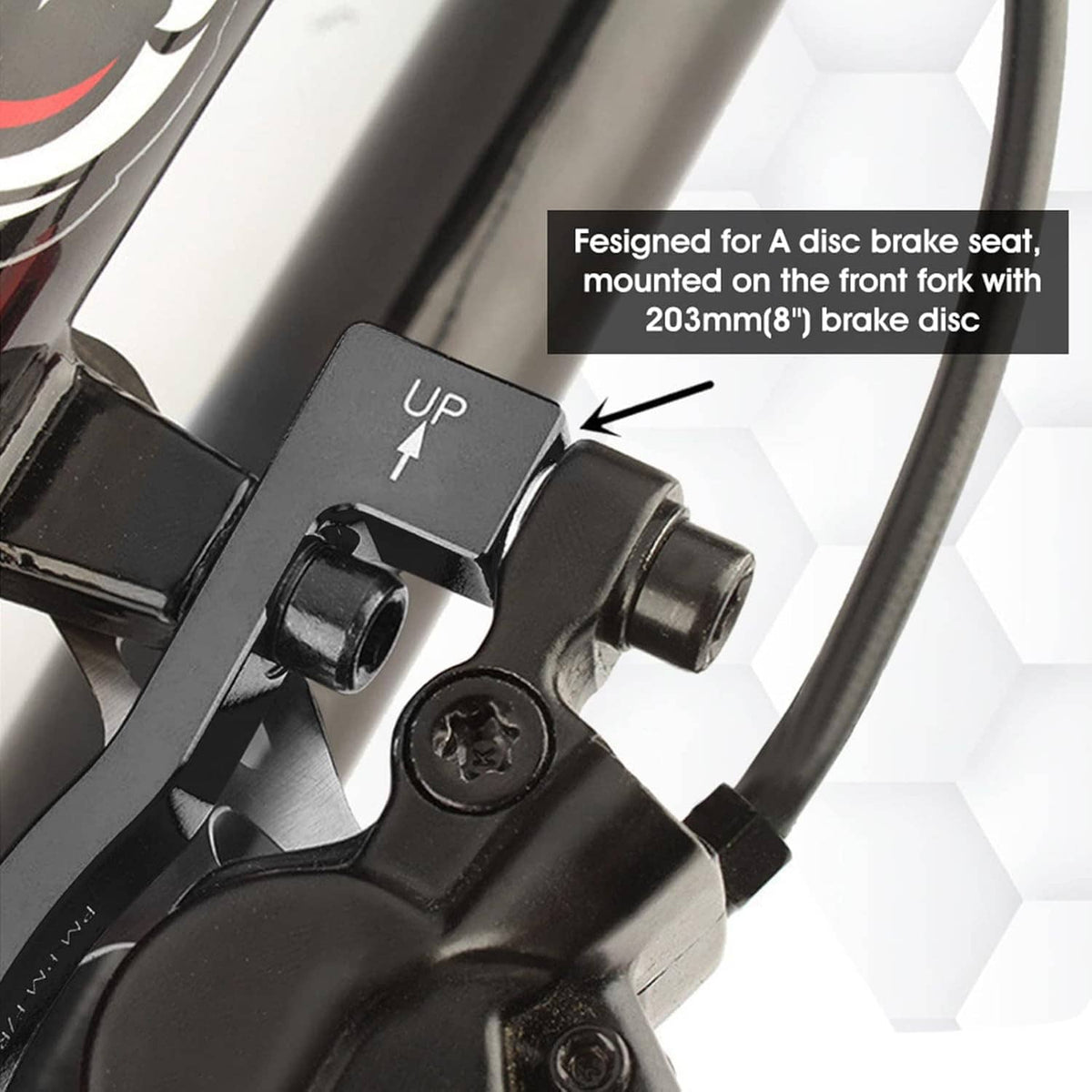 Black disc brake adapter mounted on fork, showing up arrow and side mounting hole