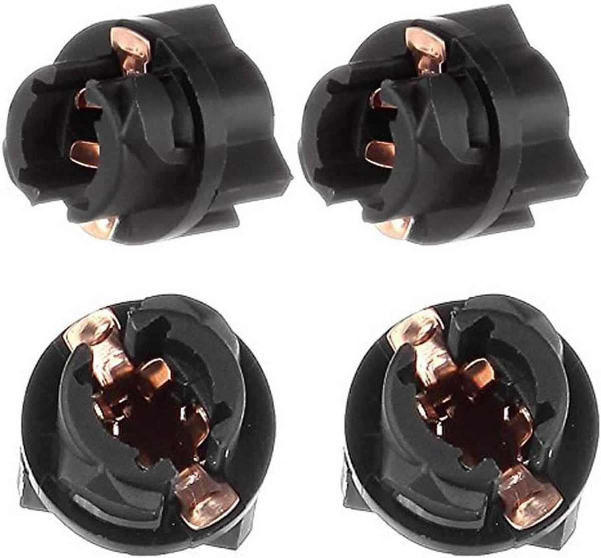 Close-up of black twist-socket wedge LED bulb terminals with copper contacts.