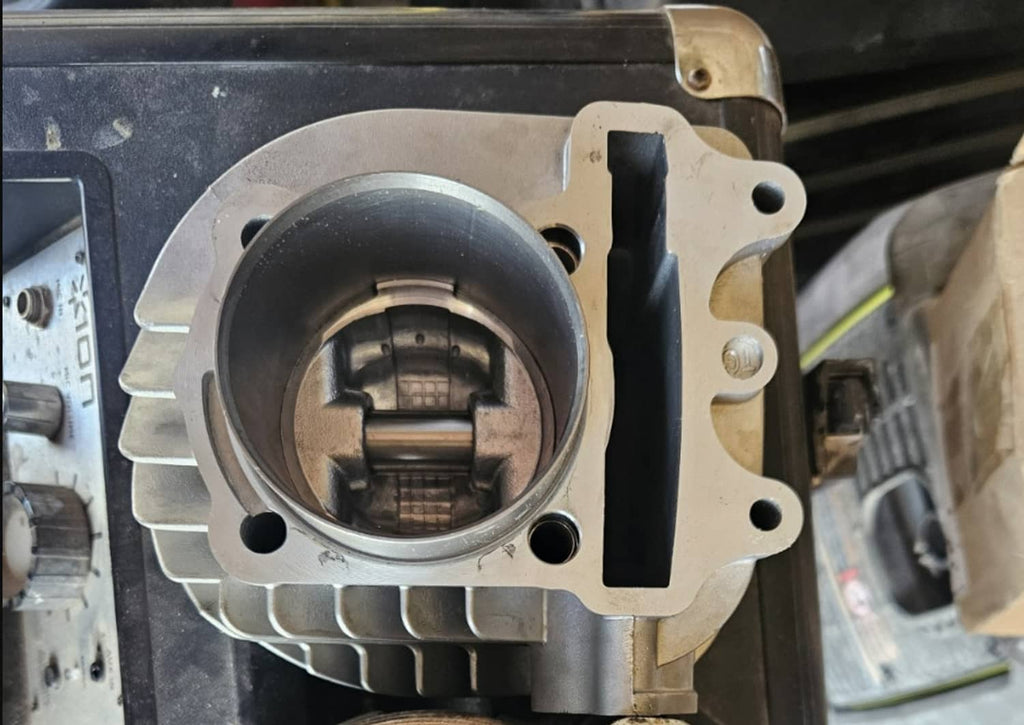 Cylinder block with open bore and finned exterior, showing piston cylinder interior