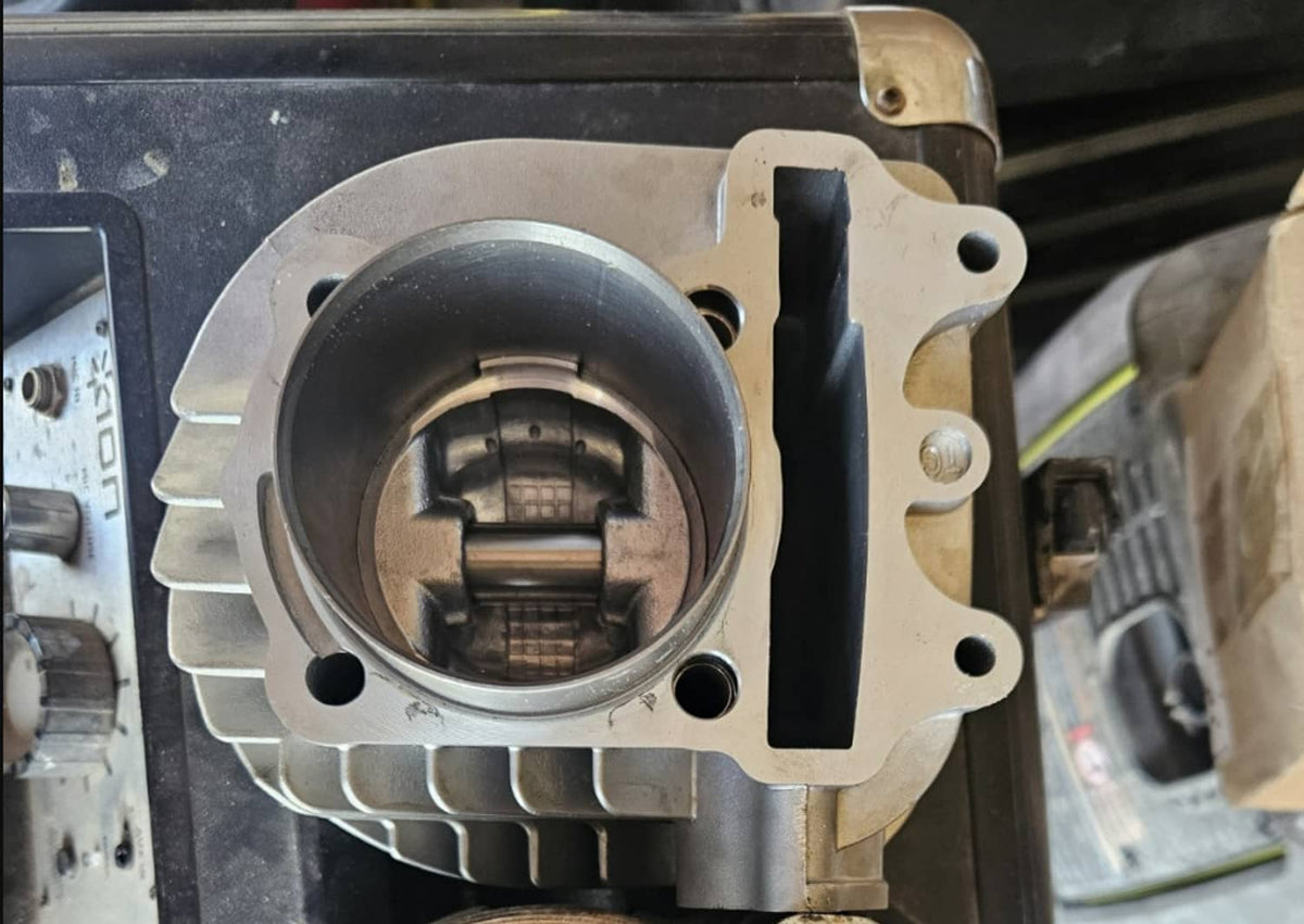 Cylinder block with open bore and finned exterior, showing piston cylinder interior