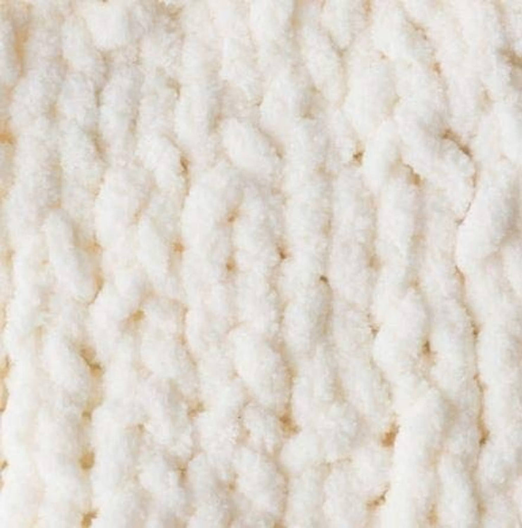 White super bulky yarn close-up with thick, plush looped texture