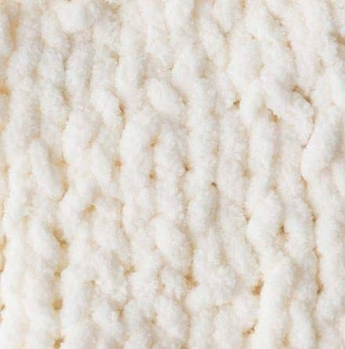 White super bulky yarn close-up with thick, plush looped texture