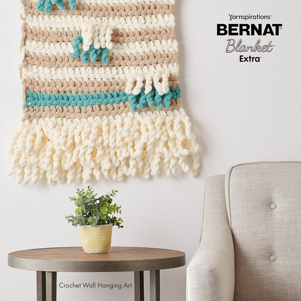 Crochet blanket with cream and teal striped texture, chunky yarn look