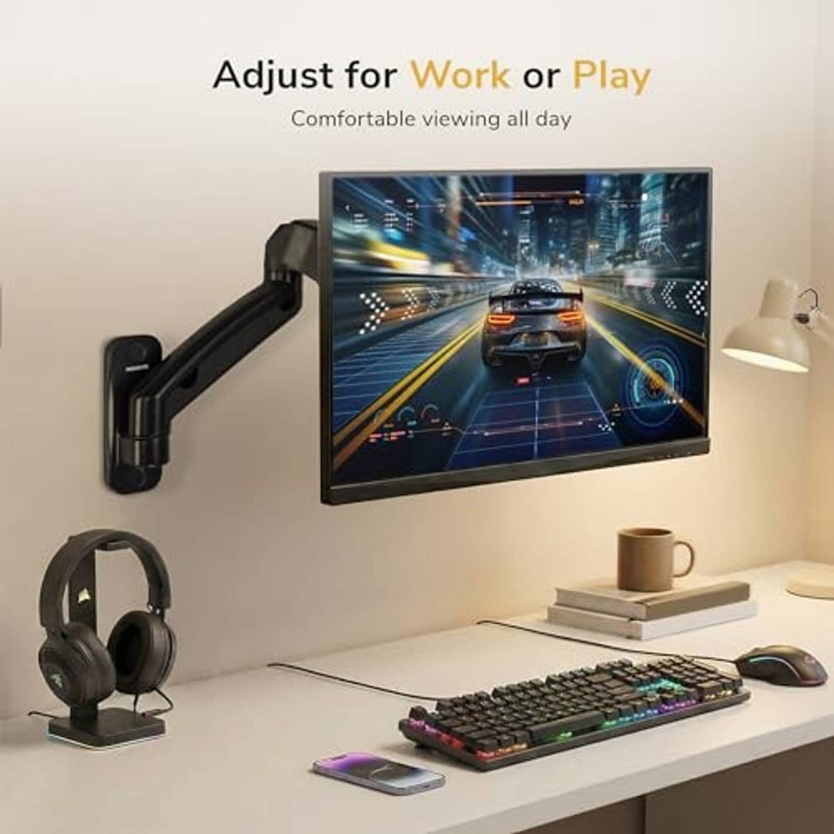 Full-motion monitor wall mount arm supporting a landscape monitor above a desk