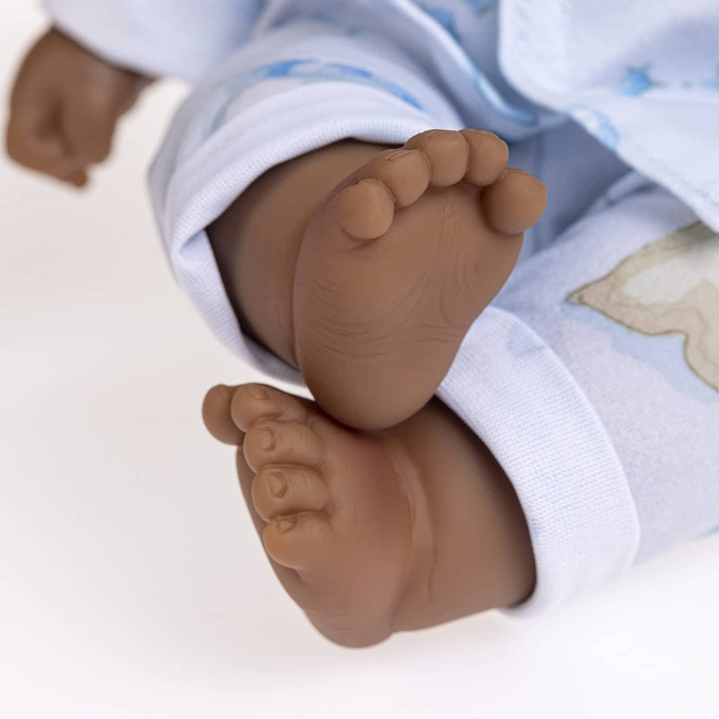 Close-up of baby doll feet in light blue patterned pajamas