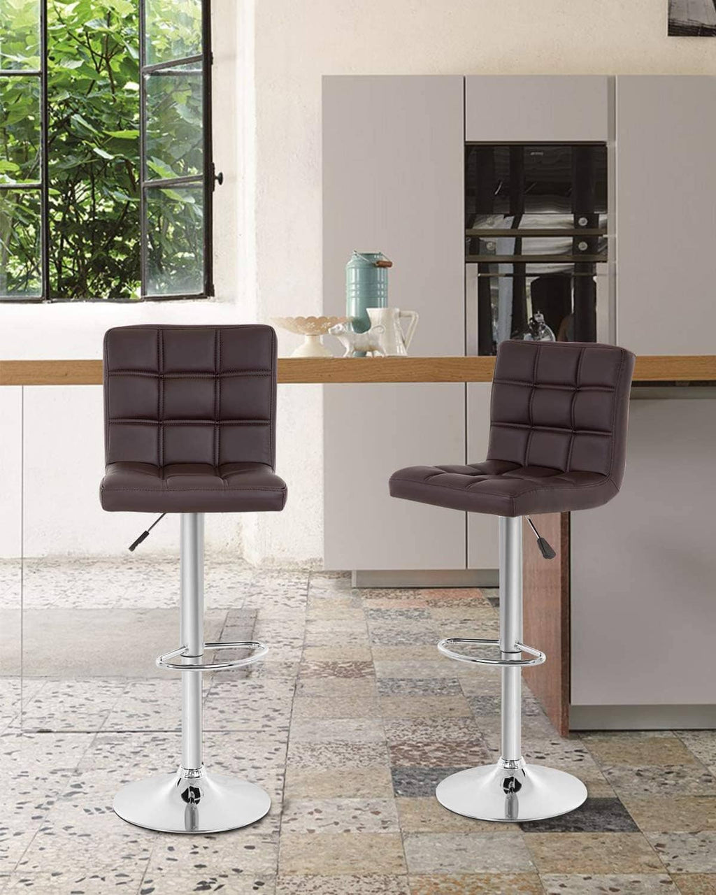 Set of 2 counter-height bar stools with dark brown tufted seats and chrome footrest bases