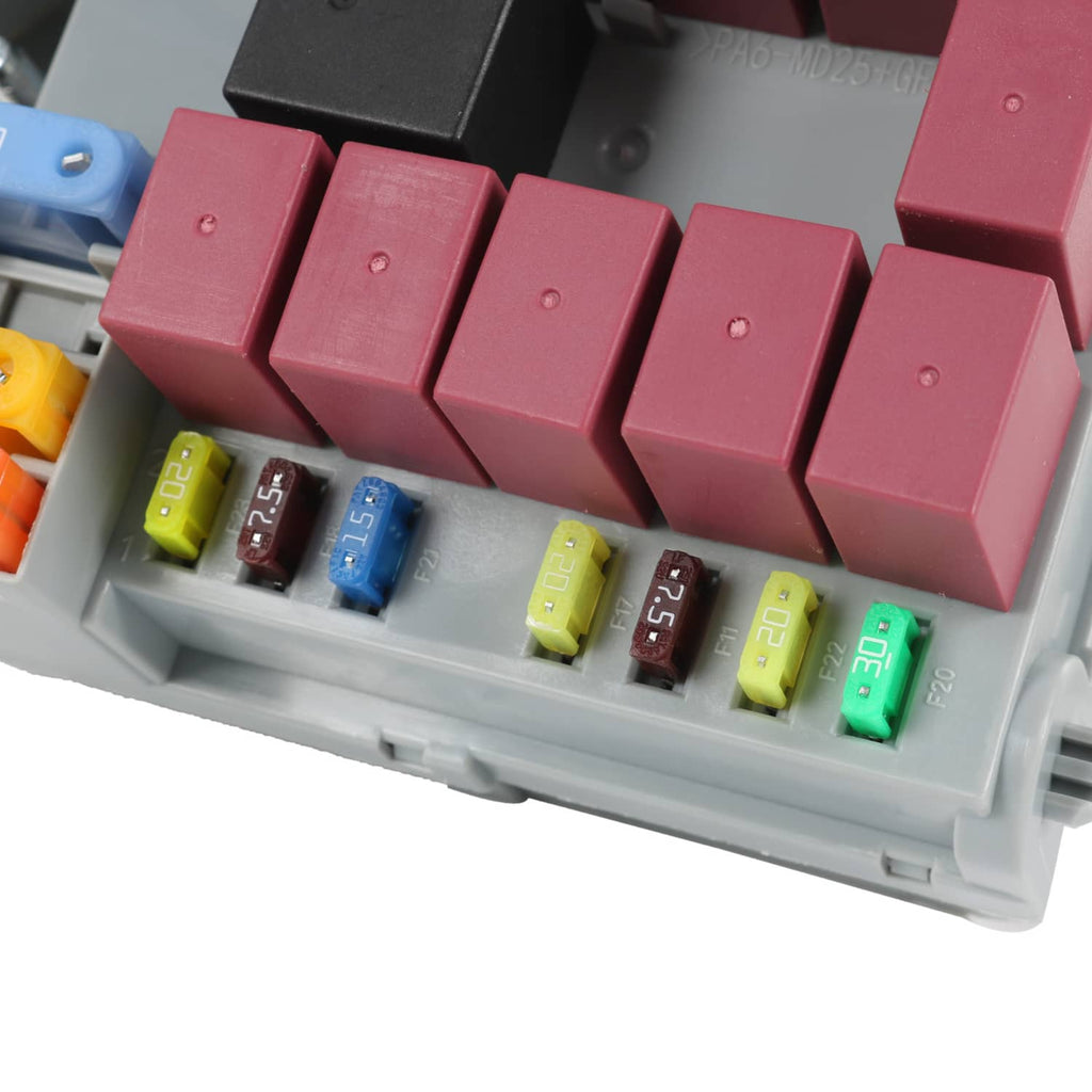 Close-up of installed blade fuses in a gray power distribution center tray