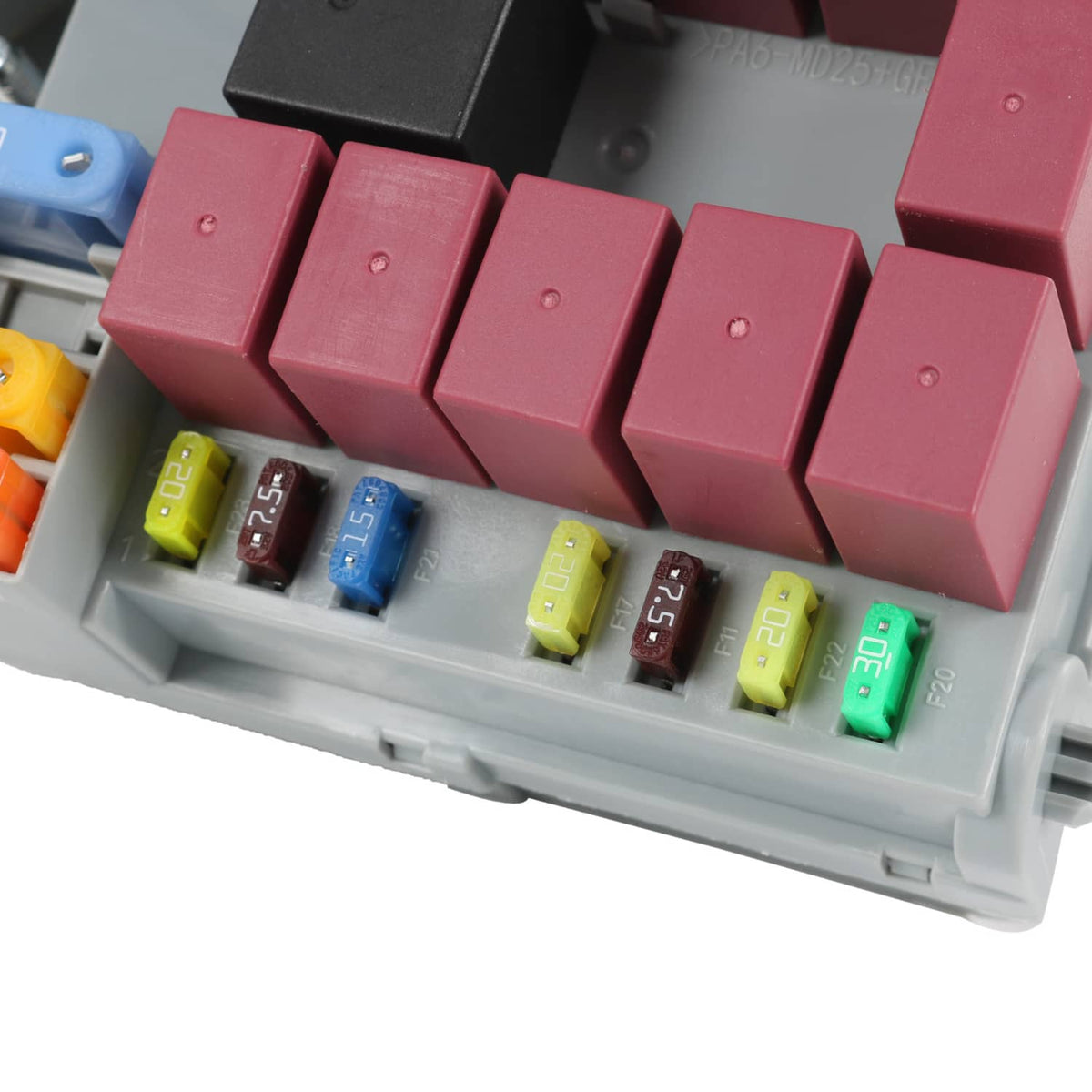 Close-up of installed blade fuses in a gray power distribution center tray