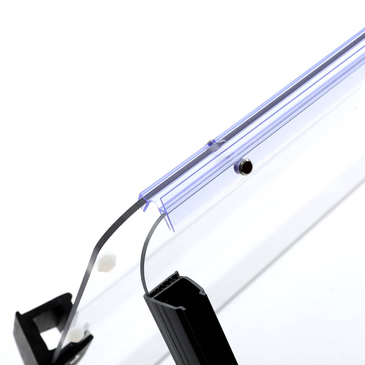 Close-up of clear windshield edge with blue frame rail and mounting hardware