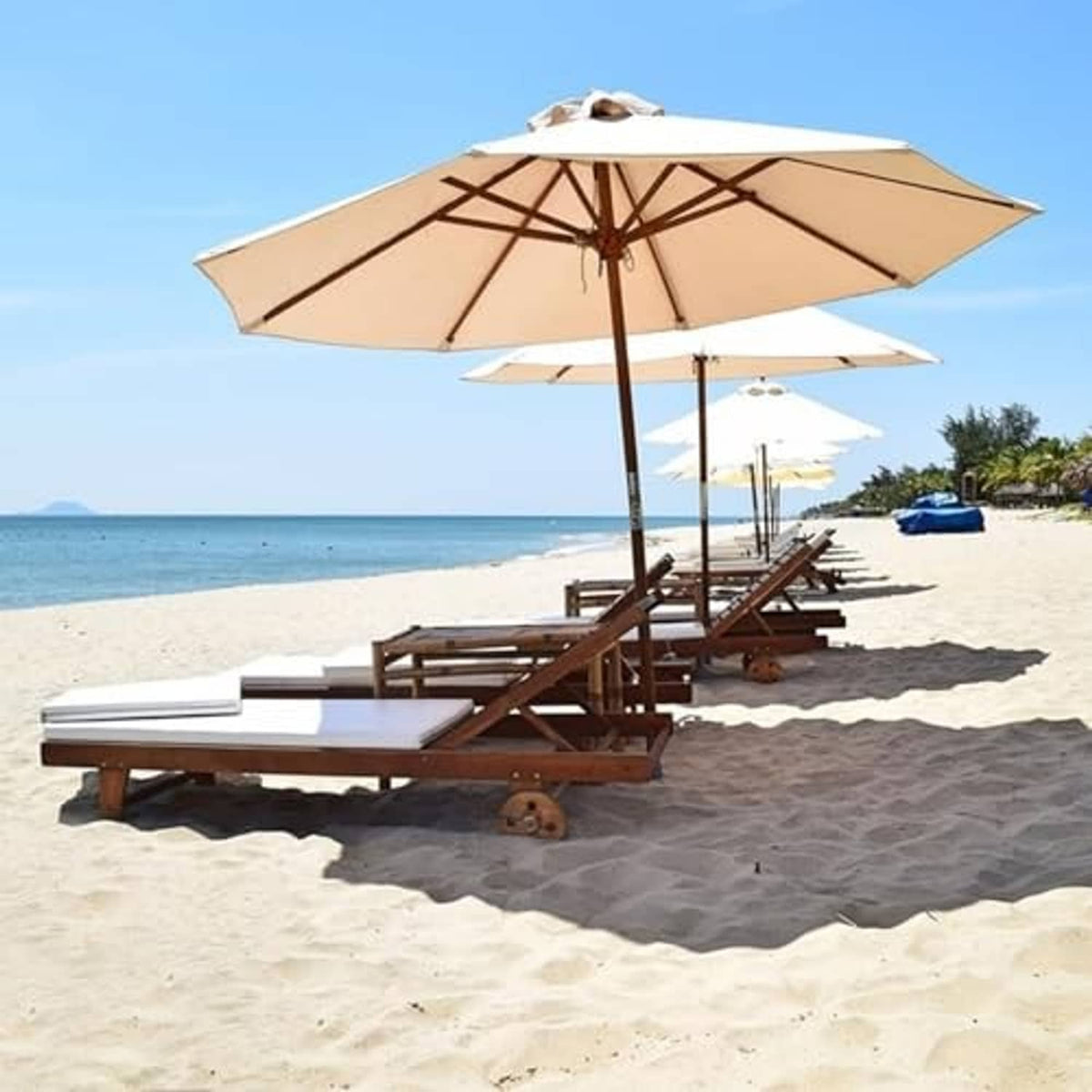 Beige outdoor umbrella canopy replacement over beach lounge chairs