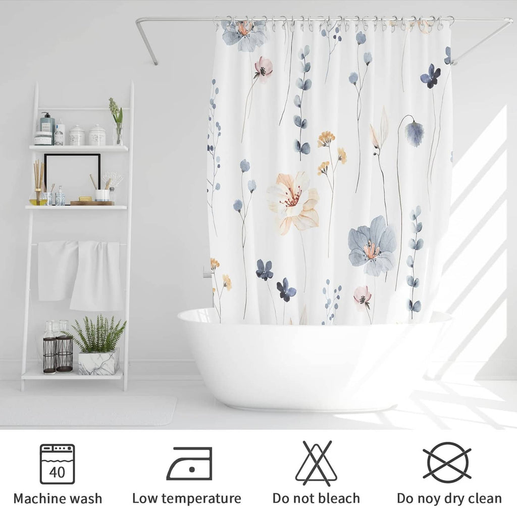 Blue and white floral shower curtain hanging in a bathtub with care symbols
