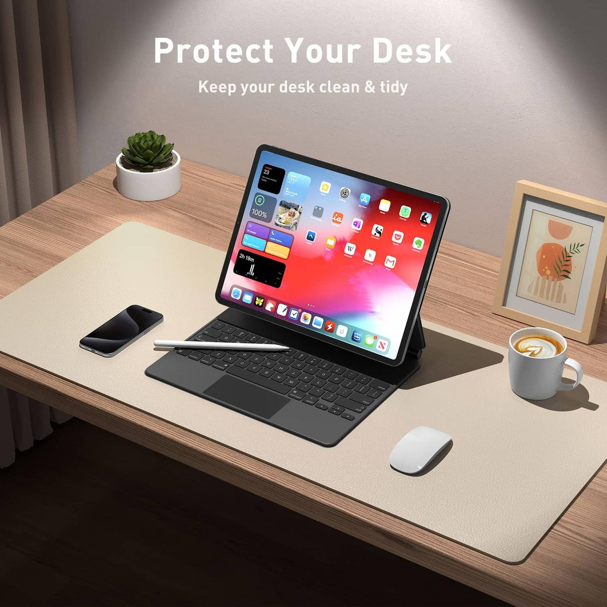 Beige desk pad protector on office desk with laptop, keyboard, and mouse