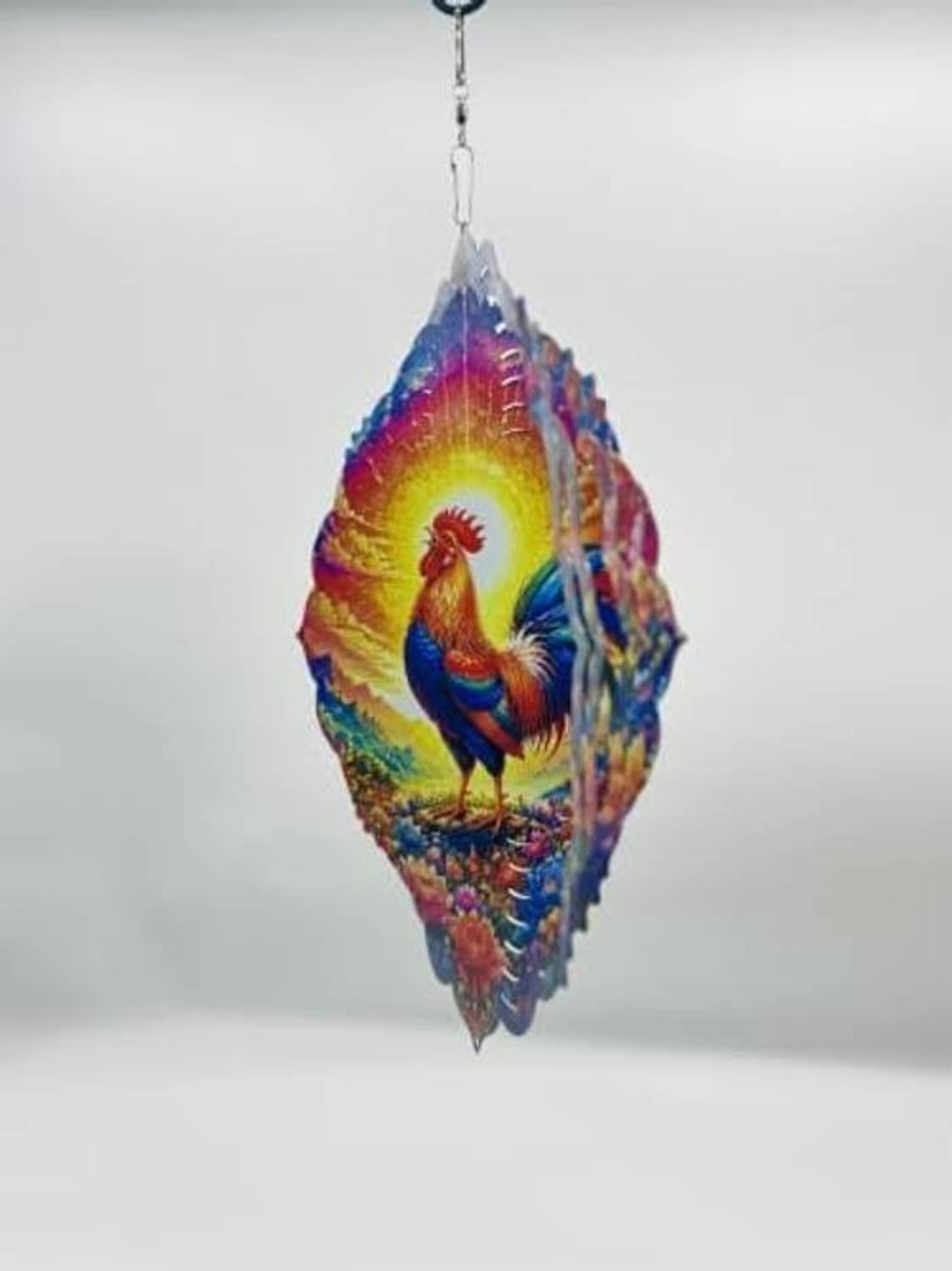 Hanging rooster wind spinner in multicolor layered metal oval shape