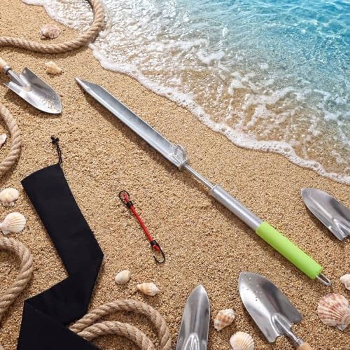 Sand spike boat anchor with neon green handle and silver pole with rope and sand tools.