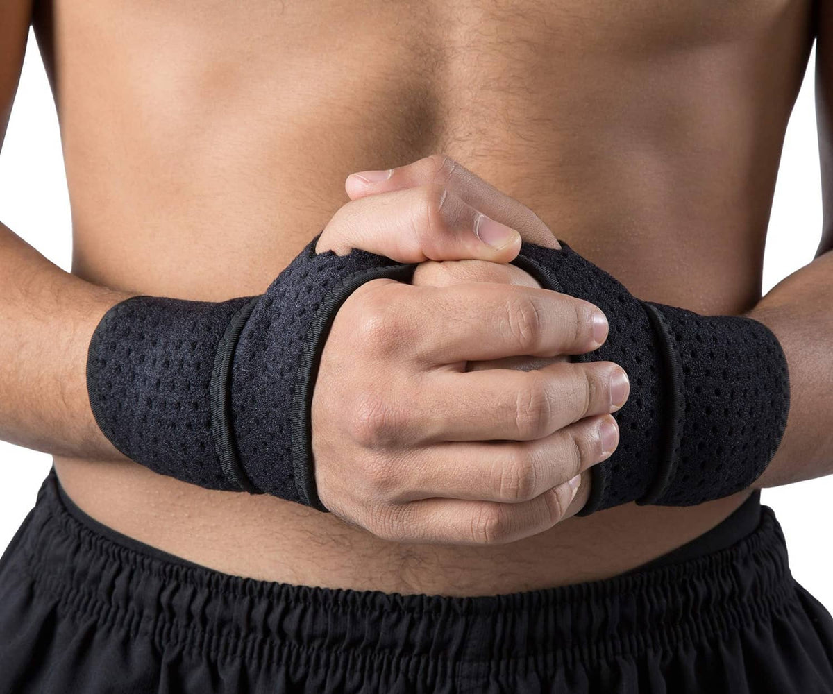 Black wrist compression straps worn on forearms with hands clasped